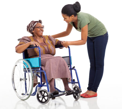 caring african girl talking to disabled senior mother on white background